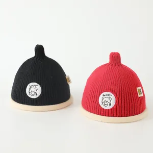 Close-up of thick ribbed knit fabric and Lucky patch on kids winter beanie hats