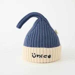 Detail of knit child beanie with bicolored design and pointed elf tip texture