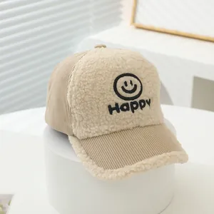 Detail of children corduroy baseball cap with fleece front and happy embroidery