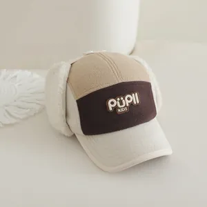 Detailed view of winter trapper hat with PUPLL embroidery and faux lamb wool earflaps