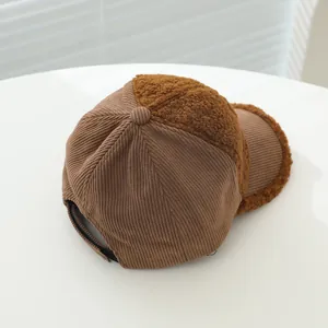 Close-up of brown corduroy and faux shearling textures on adjustable baseball cap