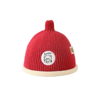 Red winter knit hat for children with Lucky letter patch and cartoon bear design