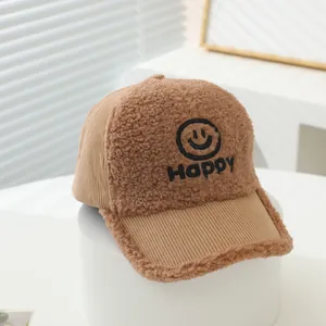Detailed view of kids corduroy baseball cap with Happy smiley face embroidery and textures