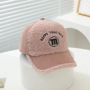 Close-up of pink corduroy kids cap with fuzzy fleece texture and M letter embroidery