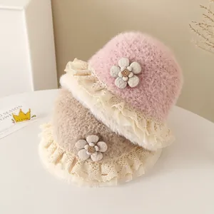 Detail of plush baby bucket hats with lace trim and decorative fabric flower