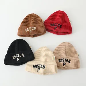 Detail of ribbed knit beanies with BOSTON P embroidery in five warm autumn colors