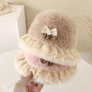 Detail of baby winter bucket hat showing lace trim and plush faux fur texture