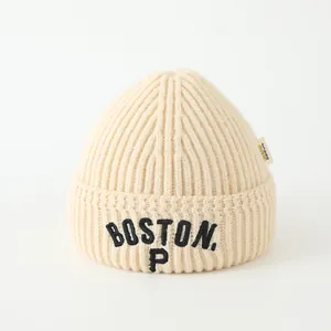 Close-up of Boston P embroidery on thick ribbed knit beanie with cream wool texture