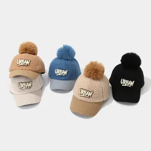 Detailed collection of five warm plush kids' baseball caps with pom poms and URBAN logo