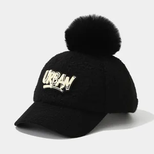 Winter faux shearling baseball cap for kids with a large pompom and Urban lettering