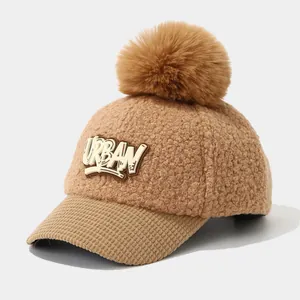 Close-up of winter kids baseball cap featuring camel faux fur texture and corduroy brim