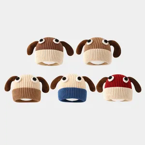 Flat lay of five assorted knit baby hats with long floppy ears and cartoon eyes