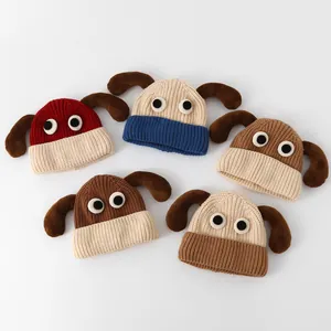 Flat lay display of five knitted infant hats with 3D animal ears and eye decorations
