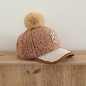 Detailed close-up of brown plush fabric and corduroy brim on kids' winter baseball cap
