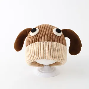 Close-up of knit texture and long dog ears on brown winter hat for toddlers