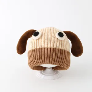 Detail of baby knit hat featuring cartoon dog ears and soft beige texture for winter
