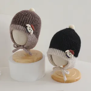 Winter knit baby earflap hats with pompom and cute puppy patch in earthy tones