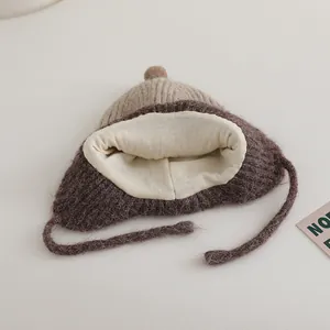 Knitted baby winter trapper hat with earflaps in beige and brown contrast design