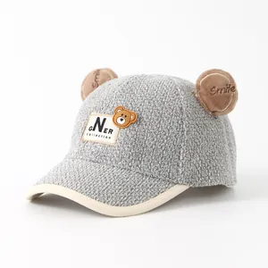 Detail view of grey fleece kid baseball cap with 3D bear ears and Smile embroidery