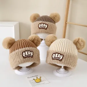 Winter knitted baby hats with fluffy bear ears in beige and brown for warmth
