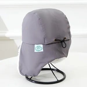 Detailed view of gray winter trapper hat with warm fleece lining and adjustable drawcord