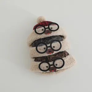 Detailed stack of leopard print winter hats with plush trim and decorative glasses