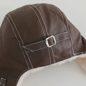 Detalle de gorro de invierno que muestra cuero marrón oscuro y forro de felpa blanca suave
