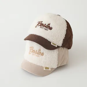 Close-up of Boston letter embroidery and quilted lamb wool fabric on winter baby caps