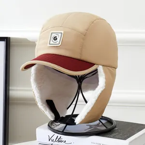 Detail of khaki aviator hat with burgundy visor, warm fleece lining and buckle strap