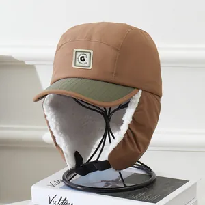 Detail of warm winter trapper hat with thick faux fleece lining and metal G logo patch