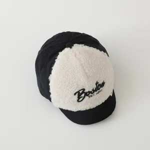 Close-up of Boston embroidery and texture on quilted winter baby baseball cap
