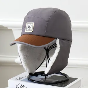 Detail of winter trapper hat showing warm white fleece lining and grey windproof fabric