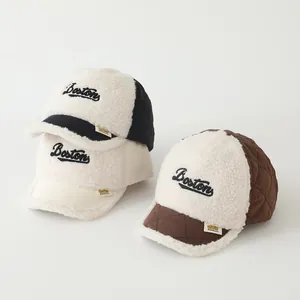 Detailed view of quilted baby baseball caps with Boston embroidery and warm sherpa fleece