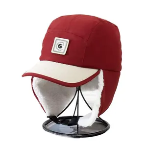 Winter thermal earflap hat for kids in red windproof fabric with white fleece lining