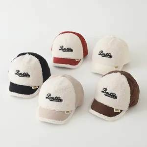 Flat lay of colorful children fleece baseball caps with Boston embroidery and quilted brims