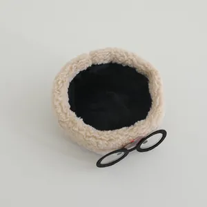 Detail of baby winter hat featuring plush sherpa fabric and fun glasses decoration
