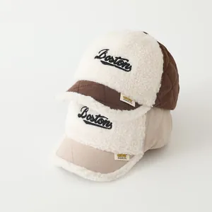 Detail of winter baseball caps showing plush sherpa fleece and quilted fabric textures
