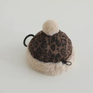Detail of leopard print plush hat-shaped mini pouch with fluffy pompom and hanging ring