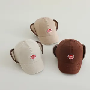 Winter fleece trapper hats for kids featuring letter patches and ear protection flaps