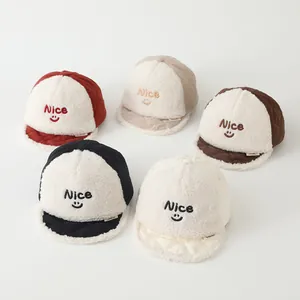 Flat lay of five color variety infant baseball caps with Nice smile embroidery