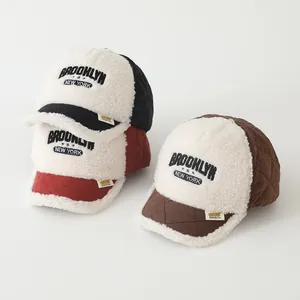 Detailed texture of lamb wool and diamond-quilted fabric on children's baseball caps