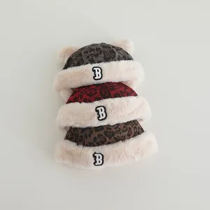 Detail of baby winter hats with leopard print patterns and plush faux fur bear ears