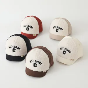 Detailed flat lay of quilted fleece baby hats in red, beige, black, brown and white
