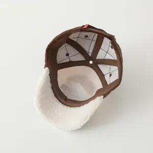Detail view of the warm quilted brown cap interior with premium fleece brim stitching