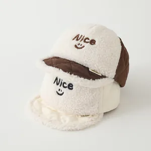 Detail of baby winter caps showing soft fleece material, Nice embroidery, and cozy textures