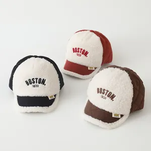 Detailed view of three baby Boston baseball caps in sherpa fleece and quilted fabric textures