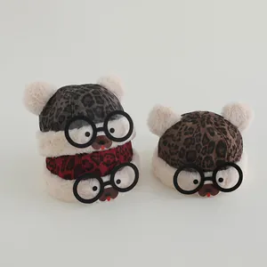 Three children winter leopard print beanies with fuzzy pompoms and cute bear faces