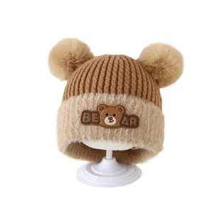 Winter baby warm knitted hat with bear patch and fluffy pom poms for ear protection