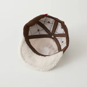 Detailed interior view of a warm baby baseball cap with cozy lamb wool brim and quilted lining