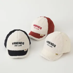 Close-up of children's fleece baseball caps featuring Friends embroidery and quilted details